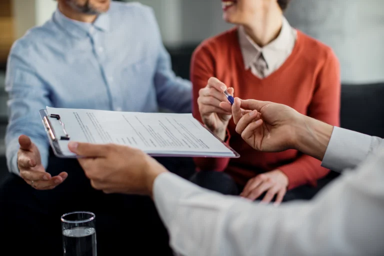 closeup-unrecognizable-couple-signing-contract-with-financial-advisor (2)